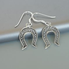 ONE PAIR of sterling silver horse shoe ear danglers. Dimensions: 12 x 17 mm Drop Length: 27 mm Weight: 1.06 gm These earrings are made of 925 hypoallergenic sterling silver. Please note this price is for ONE PAIR only. All my pieces are sent in a gift box. I can include a personal message from you if needed You are welcome to contact me at... bhavnakwintra1956@gmail.com For more beautiful pieces from my shop, please browse 👇 TOE RINGS: https://www.etsy.com/your/shops/TheSilverGame/tools/listing Elegant Horseshoe Earrings For Gift, Silver Horseshoe Jewelry Gift, Nickel-free Silver Horseshoe Jewelry, Nickel-free Horseshoe Sterling Silver Jewelry, Western Baddie, Shoe Earrings, Goodluck Charms, Country Jewelry, Silver Horse