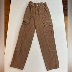 Super Cute Pants. They Are More Of A Cool-Toned Brown Than They Appear In The Pictures Due To Warm Lighting (Not Orange-Toned At All, But They Look A Little Bit That Way In The Pictures). Super Good Quality Material, Definitely Durable Pants. Great Color Of Brown For Fall. Please Message Me With Any Questions!! Utility Style Workwear Jeans With Elastic Waistband, Trendy Full-length Brown Cargo Pants, Trendy Brown Full-length Cargo Pants, Trendy Brown Full Length Cargo Pants, High Waist Brown Jeans With Pockets, High Waist Brown Jeans, Streetwear High-waisted Work Pants With Pockets, High-waisted Work Pants With Pockets For Streetwear, High-waisted Work Pants For Streetwear With Pockets