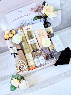 a gift box filled with personal care products and flowers on top of a wooden table