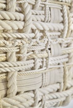 a close up view of a woven wall hanging with rope on the outside of it