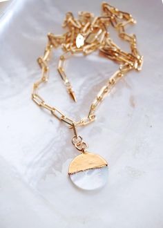 This 18kt Gold Filled Mother of Pearl Coin Charm Necklace was inspired by our endless summer and the ocean's treasures. This piece features a luminous gold dipped white mother of pearl coin on a 18kt gold filled link chain - the perfect addition to your collection.✦ DETAILS ✦✧ Name: Leimomi - (kah-OO-lah-nah) - daughter of pearls.✧ Mother of Pearl Coin measures 17mm.✧ 18kt Gold Filled Chain links measures 3.5mm x 8mm each.✧ 2 inch extenders allow for the perfect length every time.✧All Ke Aloha J Gold Mother Of Pearl Necklace For Beach, Gold Mother Of Pearl Jewelry With Pearl Charm, Luxury Gold Mother Of Pearl Shell Necklace, Gold Shell-shaped Mother Of Pearl Necklace, Elegant Shell-shaped Mother Of Pearl Necklace, Delicate Gold Bracelet, Delicate Silver Necklace, Tooth Charm, Gold Link Necklace