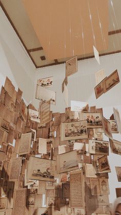 a room filled with lots of different types of papers hanging from the ceiling next to each other