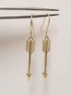 "Thanks for shopping our vintage estate store. We tend to sell well below wholesale and truly hope you enjoy all of our items. Many of the items are one of a kind, so please enjoy scrolling through the pictures and hopefully something will catch your eye. Brown spots are from camera. Nice estate 10k yellow gold love arrows earrings.  Size: 1.5\" by 4mm 1/4\" Weight: 1.51 grams Marked 10k and some that you will love." Classic Gold Heart Earrings For Anniversary, Classic Pierced Gold Heart Earrings, Classic Gold Pierced Heart Earrings, Classic Dangle Heart Earrings For Anniversary, Heirloom Jewelry With Matching Earrings For Gifts, Heirloom Jewelry Set With Matching Earrings As Gift, Gold Jewelry With Ear Wire For Anniversary, Classic Hallmarked Earrings For Valentine's Day, Nickel-free Heirloom Jewelry For Anniversary