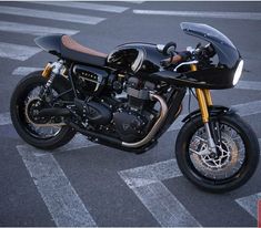 a black motorcycle parked on top of a parking lot