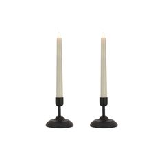 two white candles sitting on top of each other