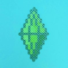 an image of a green pixellated object on a blue background