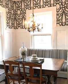 a dining room table with chairs and a bench