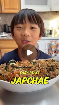 a young boy holding a plate with food in front of him and the words, easy peasy japanese on it