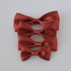 Dress to impress with our satin bow-tie! Available in 4 sizes, our bow-ties are perfect for newborns to men. With a wide range of 2024 fall and winter trending colors, they're perfect for weddings, holiday photoshoots, and any special occasion. Just slide clip over the top button and you are ready to go! • Satin ribbon• Bow-tie size • XS-0-6mos • Small 6mos.-4yrs. • Medium 4-12yrs • Large teen/adult• Handmade in the USA• Small women-owned business *Please note that bows are handcrafted and may vary slightly in size and look. Measurements are approximate. **NEVER leave children unattended or sleeping while wearing ANY hair accessories from Your Final Touch. Products may contain parts that can pose a choking hazard or strangulation. Satin Bow With Bow Tie Back For Gifts, Solid Color Bow Tie For Party, Solid Color Party Bow With Ties, Elegant Red Bow Tie Adjustable, Classic Satin Bow Tie For Gift, Classic Satin Bow Tie As A Gift, Elegant Adjustable Red Bow Tie, Party Suit And Tie Accessories With Satin Bow, Classic Satin Bow For Gifts