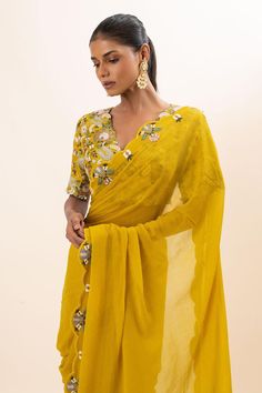 Mustard yellow scallop trimmed saree with floral embroidered motifs. Paired with a blouse with all over floral bloom embroidery using chid and thread work.
Components: 2
Pattern: Embroidery
Type Of Work: Floral, Chid, Thread
Neckline: V Neck
Sleeve Type: Half Sleeves
Fabric: Blouse: Bamber Silk, Saree: Chiffon, Lining: Mul cotton
Color: Yellow
Other Details: 
Padded blouse
Attached inner lining
Occasion: Sangeet - Aza Fashions Bloom Embroidery, Saree Chiffon, Embroidered Motifs, Padded Blouse, Yellow Saree, Embroidery Floral, Pattern Embroidery, Yellow Blouse, Silk Embroidery