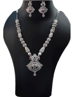 Adorn this long necklace with beautiful jhumka pendant to make yourself stylish & chic. This contemporary necklace will suit your casual & ethnic wears. They are light weight & trendy to wear. Silver Dual-tone Jewelry Sets, Elegant Silver Bridal Necklace With Latkans, Silver Necklaces With Latkans For Celebration, Silver Necklace With Latkans For Celebration, Elegant Silver Jewelry Sets With Latkans, Festival Silver Long Bridal Necklace, Silver Bridal Long Necklace For Festivals, Bridal Long Necklace In Silver For Festivals, Festival Bridal Long Necklace In Silver