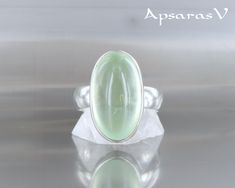 Sterling silver 925 ring set with prehnite, natural green stone and quality stone. One of a kind ring, entirely handmade, in size 8,5. The softness of the green of this Mermet stone allows, with a little imagination, to hear the birds of spring singing in all seasons. Nothing but tenderness. A harmonious balance between the natural beauty of the stone and the design of the ring body. A quality frame, both solid and delicate, designed to highlight the beauty and uniqueness of the stone that adorn Handmade Elegant Green Moonstone Ring, Elegant Handmade Green Moonstone Ring, Green Oval Prehnite Rings, Elven Ring, Colors And Emotions, Made Jewelry, 925 Ring, Rings For Her, Green Stone