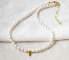 This initial pearl necklace is feminine, timeless and cute. In this gold-plated necklace, there are genuine freshwater pearls with gold-plated beads and your choice of a gold tone stainless steel letter charm. Gold Pearl Necklace With Letter Beads, Necklace With Letter, Gold Letter, Letter Charm, Real Pearls, Custom Letters, Cute Necklace, Letter Charms, Gold Letters