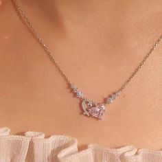 Trendy Pink Diamond Duo Heart Necklace This trendy pink diamond duo heart necklace is the perfect accessory for adding a touch of cuteness to any outfit. The two hearts symbolize love and connection, making it a meaningful addition to your collection. With its delicate design and stylish color, this necklace is sure to become your new favorite.