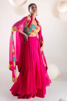 Fuchsia pink batwing sleeves cape with persian patchwork adorned with sequin highlights. Paired with a patchwork and hand embroidered blouse and a ruffled skirt. - Aza Fashions Festive Pink Set With Cape Sleeves, Pink Party Sets With Cape Sleeves, Pink Dupatta Set With Cape Sleeves, Pink Cape Sleeves Set With Dupatta, Pink Sets With Dupatta And Cape Sleeves, Pink Lehenga With Sheer Dupatta And Cape Sleeves, Festive Pink Lehenga With Cape Sleeves, Bollywood Style Pink Lehenga With Cape Sleeves, Pink Embellished Sets With Cape Sleeves