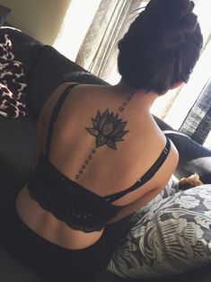 a woman with a lotus tattoo on her back