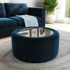 a living room with a blue couch and round coffee table