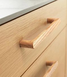 a close up of some drawers with wooden handles