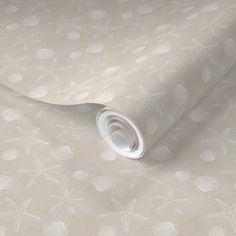 a wallpaper with shells and seashells on it's side, as well as a roll of paper