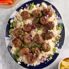 a blue plate topped with meatballs and rice