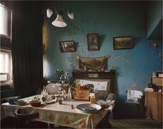 an old fashioned dining room with blue walls