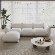 a living room with a white couch and coffee table in front of a large window