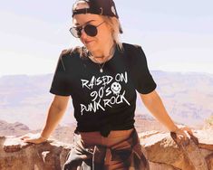 The "Raised on 90's Punk Rock" shirt, featuring a signature grunge font, pays tribute to the rebellious spirit of punk rock. Perfect for concerts, rock fests, or showing your love for the iconic genre! I T E M * D E T A I L S Bella & Canvas® tee shirts: Made with 4.2oz/142gsm ring-spun jersey.  Solid colors: 100% cotton Heather colors: 52% cotton 48% poly Next Level® racerback tank tops: Made with 4 oz/135 gsm jersey. Close fit. All colors: 60% cotton, 40% polyester. U N I S E X * S I Z I N G Sh 90s Punk Grunge, 90s Punk Rock, 90's Punk, Punk Rock Shirts, Grunge Font, Rock Fest, 90s Punk, Rock T Shirt, Concert Festival