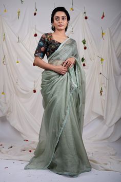 Ice green saree with embroidered border, elevated with placement embroidered buttis using resham, cutdana beads. Comes along with an unstitched blouse piece. - Aza Fashions Green Art Silk Pre-draped Saree With Embroidered Border, Designer Green Pre-draped Saree With Embroidered Border, Green Resham Embroidered Cotton Silk Blouse Piece, Pre-draped Embroidered Saree, Festive Fitted Pre-draped Saree With Embroidered Border, Pista Green Embroidered Blouse Piece For Festivals, Festival Blouse Piece In Pista Green With Embroidered Border, Fitted Tissue Silk Saree With Embroidered Border, Festive Green Pre-draped Saree With Embroidered Border