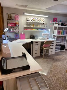 a room with desks, shelves and drawers in it