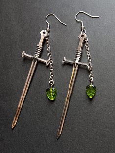 Sword earrings with leaves, perfect for any occasion! These earrings are made with hypoallergenic hooks and weigh about 0.152 ounces each. The swords are about 3.5 inches.  !If you have an issue with the sound of metal hitting each other be cautious buying these!  Thank you for checking out this listing, have a great day! Sound Of Metal, Design Journal, The Sound, Swords, Have A Great Day, Jewelry Earrings Dangle, Etsy Earrings, Dangle Drop Earrings, Dangle Earrings