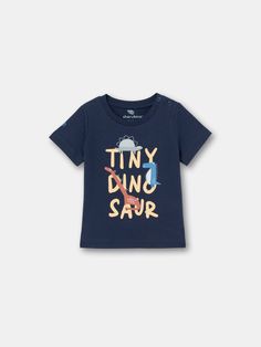 This tee is the ultimate combination of cool and cozy! With its eye-catching Tiny Dino print is sure to turn heads and make a statement. Made from high-quality materials, it's soft, warm, and perfect for any occasion. Playful Printed Short Sleeve T-shirt, Unisex Short Sleeve T-shirt For Playtime, Screen Print Short Sleeve T-shirt For Playtime, Casual Printed T-shirt For Playtime, Casual Printed T-shirt For Play, Casual Graphic Print Tops For Playtime, Blue Fun T-shirt For Playtime, Fun Blue T-shirt With Slogan, Playful Slogan Crew Neck T-shirt