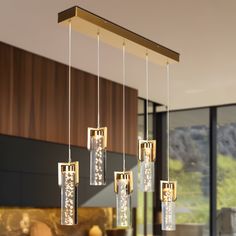 a modern chandelier hanging from the ceiling in a living room or dining room