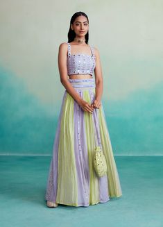 The amaya skirt top set is a delightful 3-piece ensemble in a charming lavender and lime color combination. The blouse is adorned with intricate mirror work hand embroidery on both the front and back, adding a touch of elegance to your look. The skirt features beautiful paneling with mirror work and comes with an embroidered belt adorned with tassels and more mirror work, creating a flattering silhouette that's sure to turn heads. To complete the set, we've included a stunning shisha embroidery Paneling With Mirror, Chanderi Lehenga, Digital Lavender, Lavender Outfit, Haldi Outfit, Skirt Top Set, Lime Color, Lavender Dresses, Work Skirts