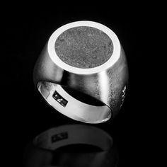 Sterling silver round "ADAMAS" urban ring. Weight: 14 gr. Sizes: 55-66 EU / 7-11.5 US Product Description:  Make a bold statement with this handcrafted men's sterling silver ring, featuring an eye-catching volcanic lava stone inlay. This unique signet ring combines the raw beauty of natural lava stone with the sleek elegance of sterling silver, creating a piece that is both rugged and refined. The smooth, brushed silver band contrasts beautifully with the textured, dark lava stone, making it a s Modern Hallmarked Round Signet Ring, Modernist Oval Signet Ring For Gift, Modernist Oval Signet Ring As Gift, Modernist Oval Rings With Polished Finish, Modernist Oval Sterling Silver Ring, Modernist Dome Ring With Polished Finish, Polished Modernist Dome Ring, Modernist Polished Signet Ring, Modern Silver Engraved Dome Ring