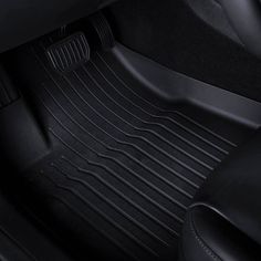 the front and rear floor mats on a car, with black leather trimmings