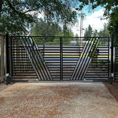 an iron gate in the middle of a driveway