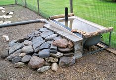 an outdoor grill made out of rocks and wood