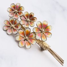 This vintage Italian gilt .800 silver filigree pique a jour brooch showcases a beautiful flower bouquet. Each flower painted in a pink, orange and white enamel gradient. This brooch weighs 6.6 grams and measures 54mm in length. It is in great vintage condition with light wear and is marked as shown. Gold Brooches For Spring Gift, Flower-shaped Enamel Brooches For Wedding, Flower Shaped Enamel Brooches For Wedding, Pink Flower Enamel Brooch, Wedding Flower-shaped Enamel Brooches, Spring Gold Brooch Jewelry, Spring Season Gold Brooch Jewelry, Spring Gold Jewelry Brooch, Gold Brooch Jewelry For Spring