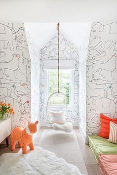 the room is decorated in bright colors and features an animal - themed wallpaper pattern