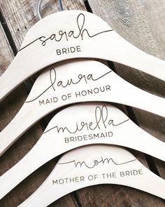 four wooden hangers with names on them