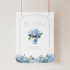 a card with blue flowers in a vase