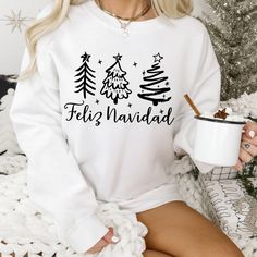 Feliz Navidad Sweatshirt, Feliz Navidad Shirt, Feliz Navidad Matching Shirts, Christmas Matching Shirts, Spanish Christmas Shirt, Xmas Shirt, felices fiestas shirt .: Made with a medium-heavy fabric blend of 50% cotton and 50% polyester (8.0 oz/yd² (271.25 g/m this sweatshirt feels cozy and is the perfect choice for those colder months. .: The classic fit along with the crew neckline deliver a comfy wearing experience with a clean-cut style. Meanwhile, the double-needle stitching at the shoulder Festive Long Sleeve White T-shirt, Relaxed Fit Long Sleeve Holiday T-shirt, Relaxed Fit Long Sleeve T-shirt For Holiday, White Long Sleeve T-shirt For Holiday, Christmas Matching Shirts, Fiesta Shirt, Spanish Christmas, Christmas Matching, Xmas Shirts