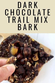 chocolate trail mix bark on a wooden cutting board with text overlay that reads, dark chocolate trail mix bark