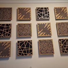 nine wooden squares with black and white designs on the sides, all arranged in different directions