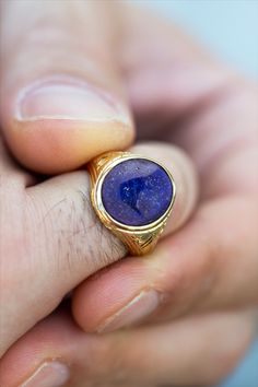 A beautiful signet ring with carvings on the sides made by hand and a cabochon lapis lazulis gemstone in the center. *real images of the ring, taken by us* Lapis Lazuli Stone Size: 14x12mm Material: - Sterling Silver 925 - 9K Gold (375) - 14K Gold (585) - 18K Gold (750) *All signet rings are hallmarked on the back for certification* - We offer FREE Worldwide DHL & FedEx Shipping! - Branded DanelianJewelry Gift Box with each order! Sapphire Signet Ring For Promise, Classic Lapis Lazuli Ring With Polished Finish, Classic Lapis Lazuli Jewelry Ring, Sapphire 14k Gold Signet Ring Gift, Symbolic Gemstone Signet Ring As Gift, 14k Gold Sapphire Signet Ring As Gift, Carved 14k Gold Signet Ring As Gift, Luxury Lapis Lazuli Gemstone Rings, Spiritual Gemstone Signet Ring For Anniversary