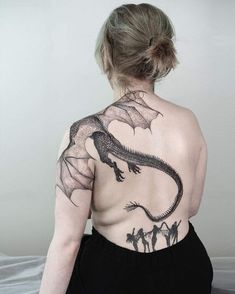 a woman with a dragon tattoo on her back