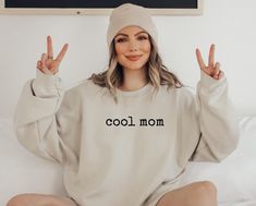 Funny Cool Mom Sweatshirt, Cute Mom Sweatshirt, Gift for Mom, Mother's Day Gift, Xmas Gift for Mom, Birthday Gift for Mom, New Mom Shirt *JUST RELEASED* * Custom Design * Limited Edition * *This item is NOT available in stores* Show your Mom love with this custom, limited edition "cool mom" sweatshirt.  Ideal for any situation, a unisex heavy blend crewneck sweatshirt is pure comfort. These garments are made from polyester and cotton. This combination helps designs come out looking fresh and beautiful. The collar is ribbed knit, so it retains its shape even after washing. There are no itchy side seams on these sweaters.  .: Made with a medium-heavy fabric blend of 50% cotton and 50% polyester (8.0 oz/yd² (271.25 g/m this sweatshirt feels cozy and is the perfect choice for those colder mont Cotton Sweatshirt For Birthday In Winter, Cotton Sweatshirt For Winter Birthday, Cool Crew Neck Tops For Winter, Casual Slogan Sweatshirt For Mother's Day, Casual Sweatshirt For Birthday And Mother's Day, Casual Mother's Day Slogan Sweatshirt, Casual Winter Birthday Sweatshirt, Casual Cotton Sweatshirt For Birthday, Cool Cotton Winter Tops