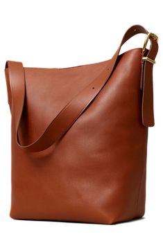 Madewell's newest leather bag is cool, modern and quietly luxe. With a magnetic closure and interior pocket, the bucket tote is perfectly sized to hold up to a 15" laptop, water bottle, phone, wallet, keys and more. It's so good that it's essential. Magnetic closure Adjustable shoulder strap Interior wall pocket Fits most 15" laptops Unlined Leather Imported Madewell Transport Tote, Madewell Handbags, Madewell Bags, Bucket Tote, Leather Industry, Gorgeous Leather, Bag Collection, Leather Bucket Bag, Shopper Tote