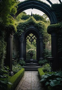 an archway in the middle of a lush green garden