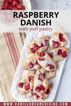 raspberry danish with puff pastry on a white plate next to bowls of raspberries